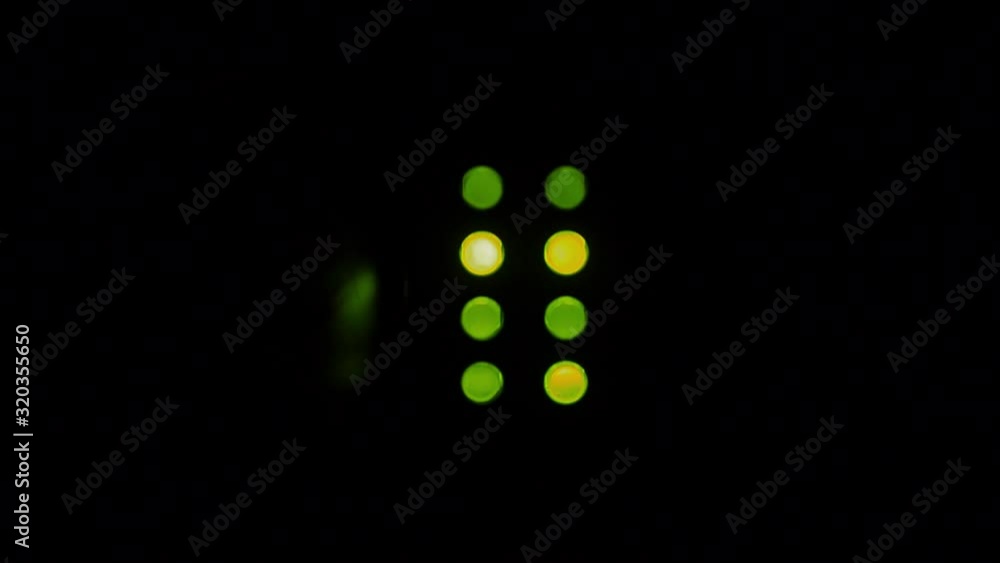 Eight, green LED indicator lights in a dark room blinking to indicate the status of a system, with copy space. Eight, green LED indicator lights in a dark room blinking to indicate the status of a system, with copy space.