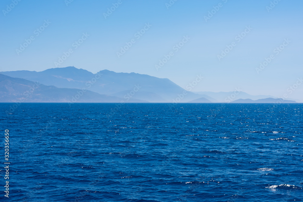 Summer seascape with mountains and blue sea water