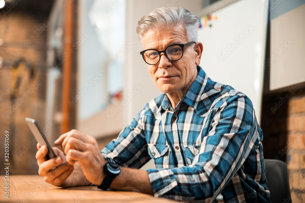 Smiling adult man looking at camera at the office Smiling adult man looking at camera at the office