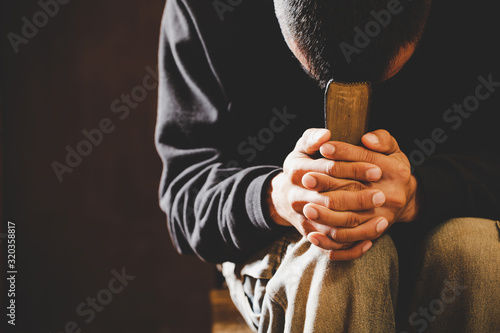 Portrait of a man praying with his eyes closed. photo