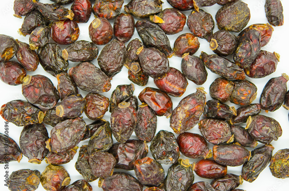Rosehip fruit, dried fruit close-up on a white background. Healthy food, vegetarianism. Rosehip fruit, dried fruit close-up on a white background. Healthy food, vegetarianism.