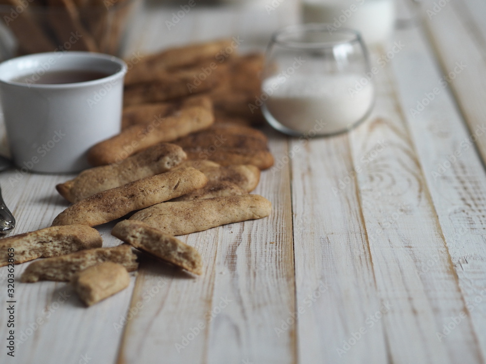 Fototapeta premium Homemade shortbread biscuits with cinnamon and nuts on a white wooden table. We bake cookies.