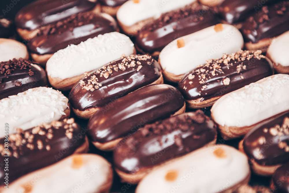 Traditional french eclairs with chocolate. Tasty dessert. Home made cake eclairs Sweet. Dessert. Pastry filled with cream. Chocolate icing. Traditional french eclairs with chocolate. Tasty dessert. Home made cake eclairs Sweet. Dessert. Pastry filled with cream. Chocolate icing.