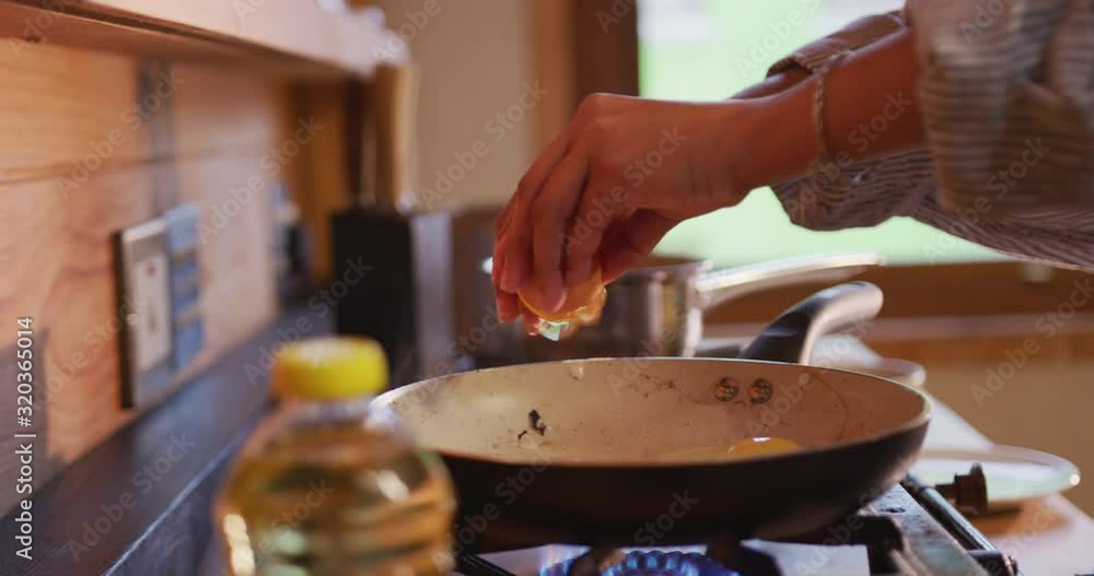 Mixed race woman preparing breakfast at home Mixed race woman preparing breakfast at home