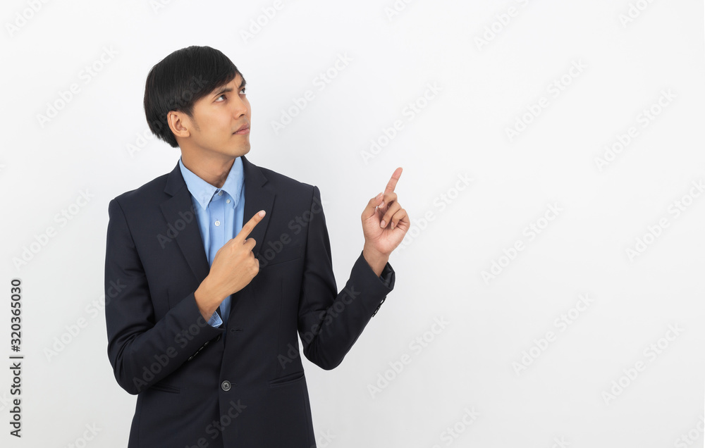 Young asian business man with blue shirt pointing to the side with a hand to present a product or an idea isolated on white background. Young asian business man with blue shirt pointing to the side with a hand to present a product or an idea isolated on white background.