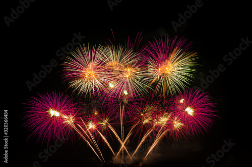 Abstract and brightly colorful firework in the celebration and anniversary festival.Merry Christmas and New year party light over night sky.