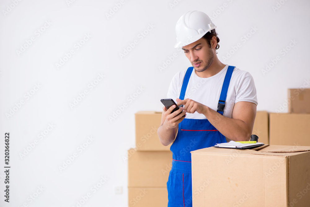 Young male professional mover doing home relocation Young male professional mover doing home relocation