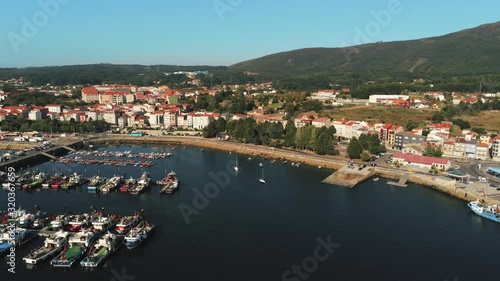 Traditional fisher boats on Pobra caraminal aerial view of town bay and marina. Slow pan right, beautiful sunny day. photo