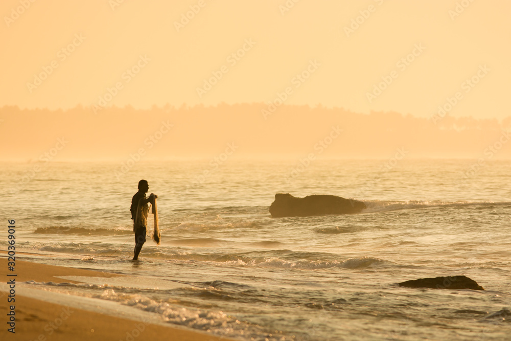 Fisherman on the sandy beach during sunrise, Sri lanka, Tangalle, Asia