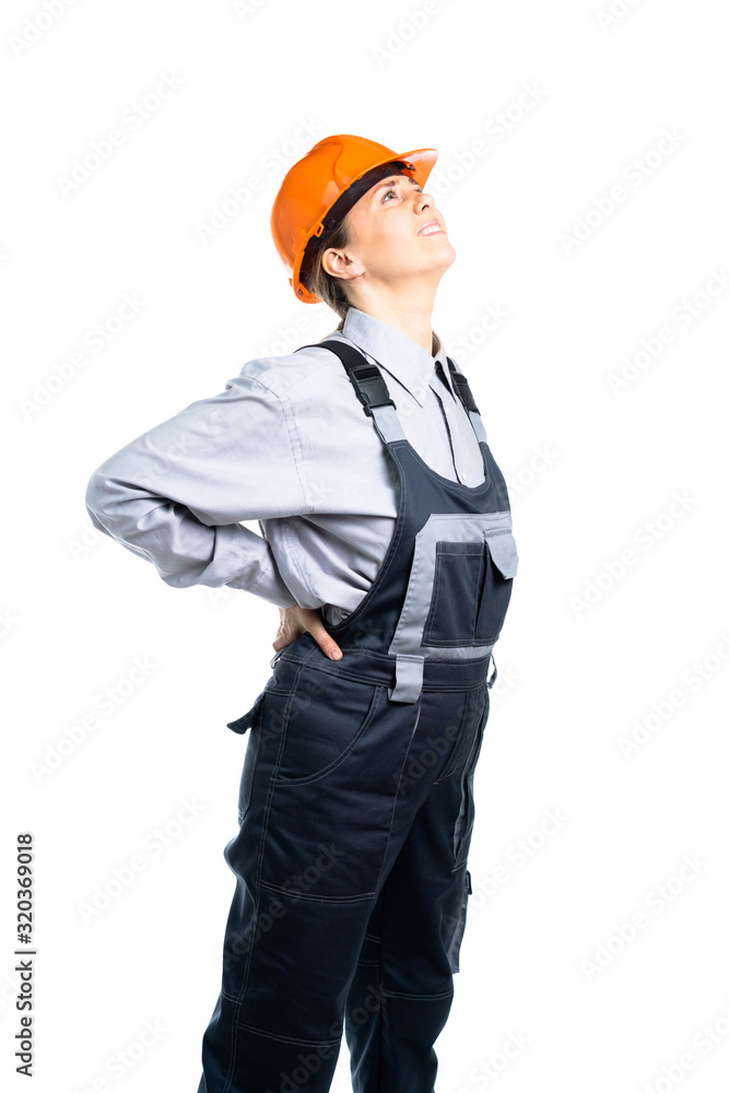 Female engineer has a backache. Pain in the spine from work. Isolated Female engineer has a backache. Pain in the spine from work. Isolated