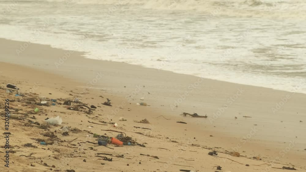 The sea returned the garbage dumped by humans in the water on the beach of Desaru, Malaysia - wide shot The sea returned the garbage dumped by humans in the water on the beach of Desaru, Malaysia - wide shot