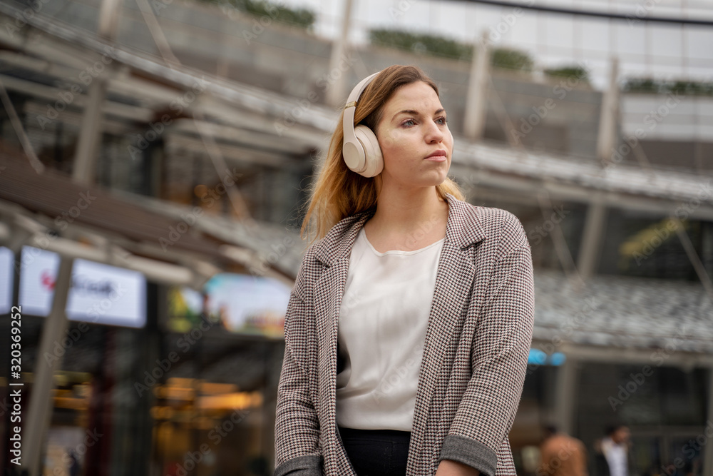 Fototapeta premium Blonde Teenager Listening To Music With Headphones