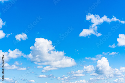 Blue sky background with clouds, copy space for text. © Pattarisara