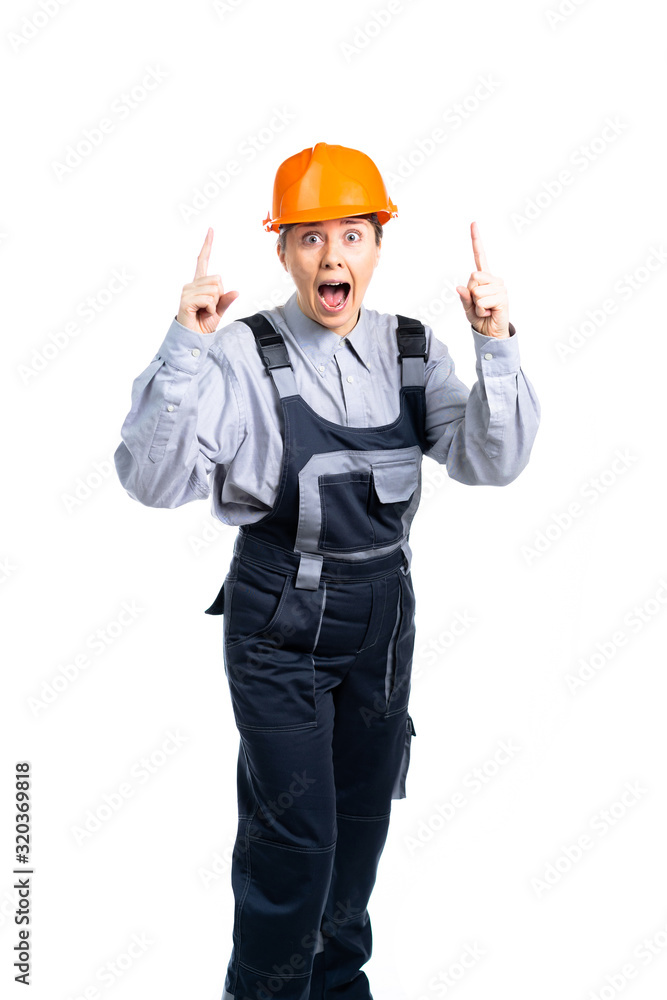 Female construction engineer points fingers to the side from a blank of text. Isolated