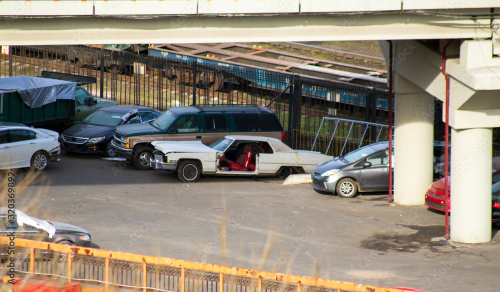 old disassembled American car under the bridge old disassembled American car under the bridge