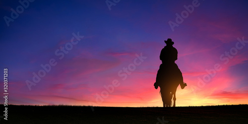 Cowboy on a horse at sunset