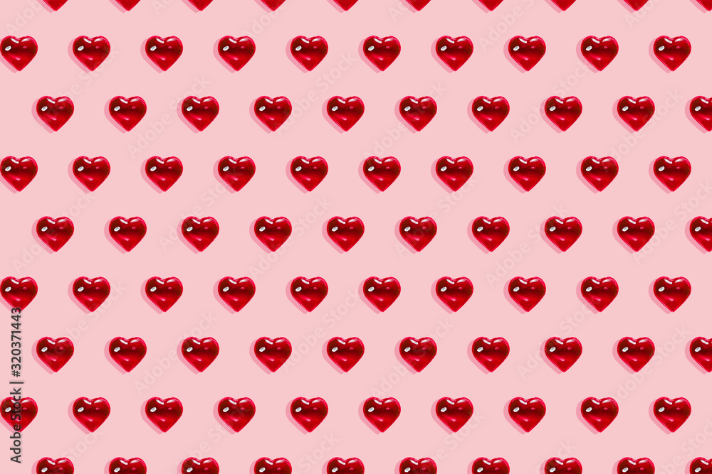 Valentine's day background. Pattern of glass red hearts on a pastel pink background. Card minimalism, Symbol of love Valentine's day background. Pattern of glass red hearts on a pastel pink background. Card minimalism, Symbol of love