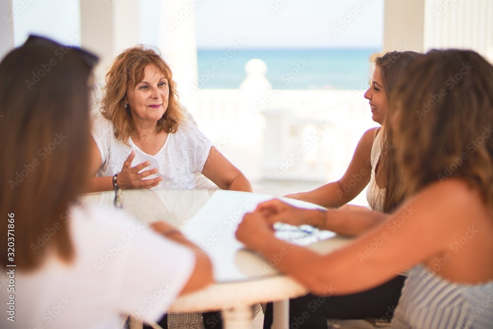 Beautiful group of women sitting at terrace speaking and smiling Beautiful group of women sitting at terrace speaking and smiling