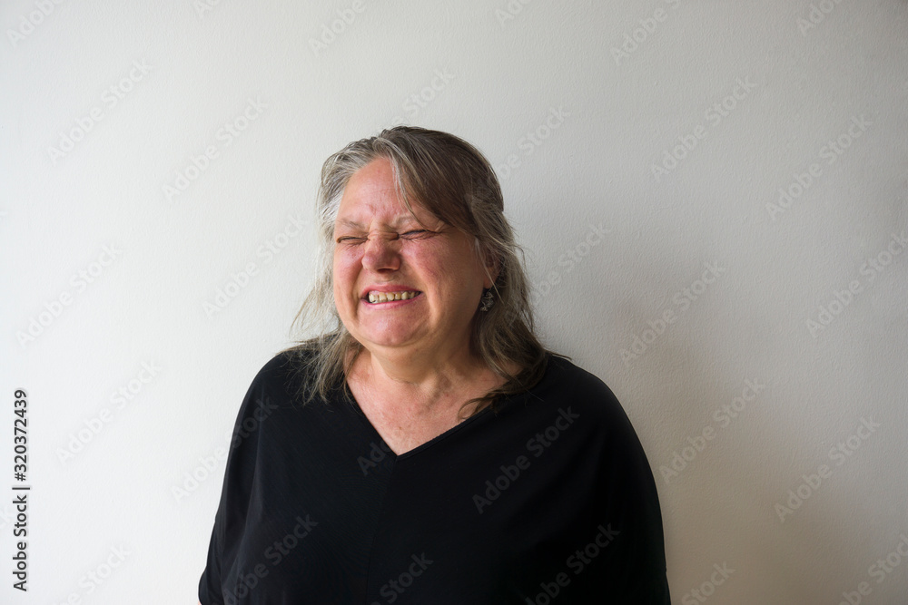 Old woman disgusted face expression. Elder modern woman closed her eyes as breathing bad smell. Senior (middle aged) woman revealing her emotions on white background. Old woman disgusted face expression. Elder modern woman closed her eyes as breathing bad smell. Senior (middle aged) woman revealing her emotions on white background.