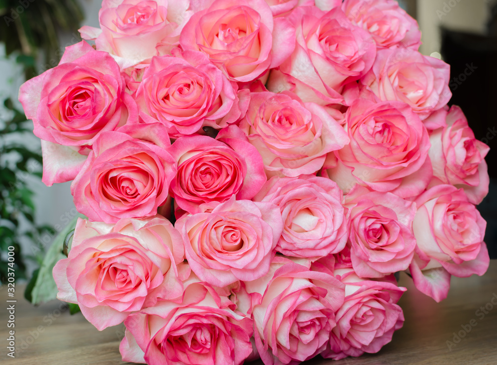 bouquet with delicate fragrant rose flowers on a wooden background, a gift for the holiday bouquet with delicate fragrant rose flowers on a wooden background, a gift for the holiday