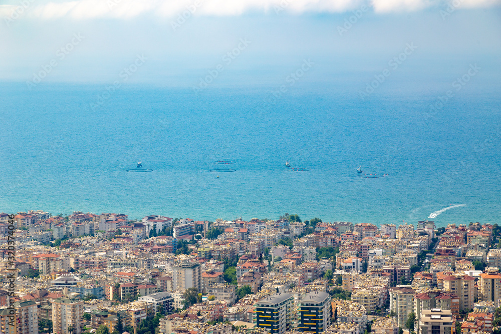 Obraz premium Fishing at the sea near the urban region. Several fishing boats with open water nets during fishing.
