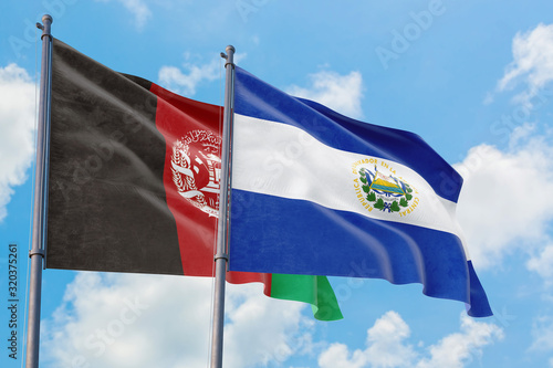 El Salvador and Afghanistan flags waving in the wind against white cloudy blue sky together. Diplomacy concept, international relations.
