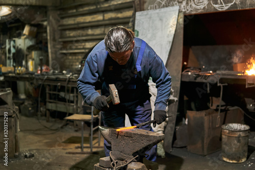male traditional blacksmith at work