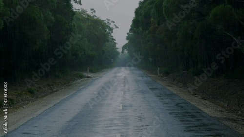 View down old country road during rain storm, rainy weather photo