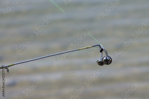 Bells for fishing rod on a blurred background to hear the catch. For the desktop.