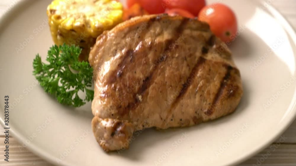 grilled and barbecue fillet pork steak with corn, carrot and tomatoes grilled and barbecue fillet pork steak with corn, carrot and tomatoes