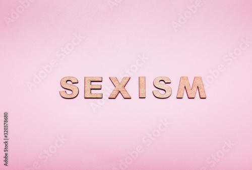 The word sexism in on a pink background