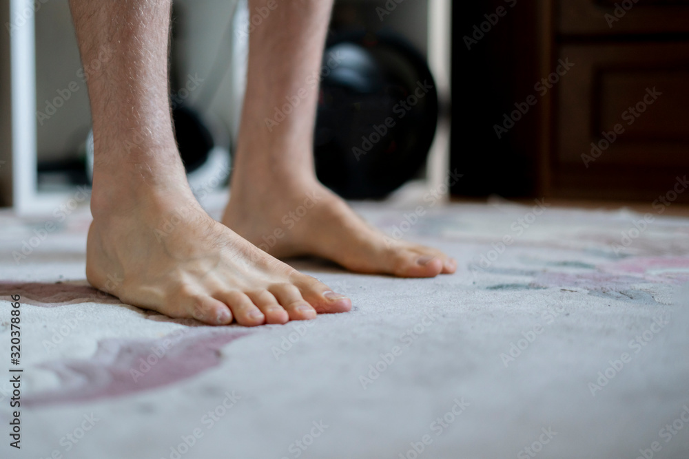 the bare feet at home on the carpet on the floor, wake up early in the morning