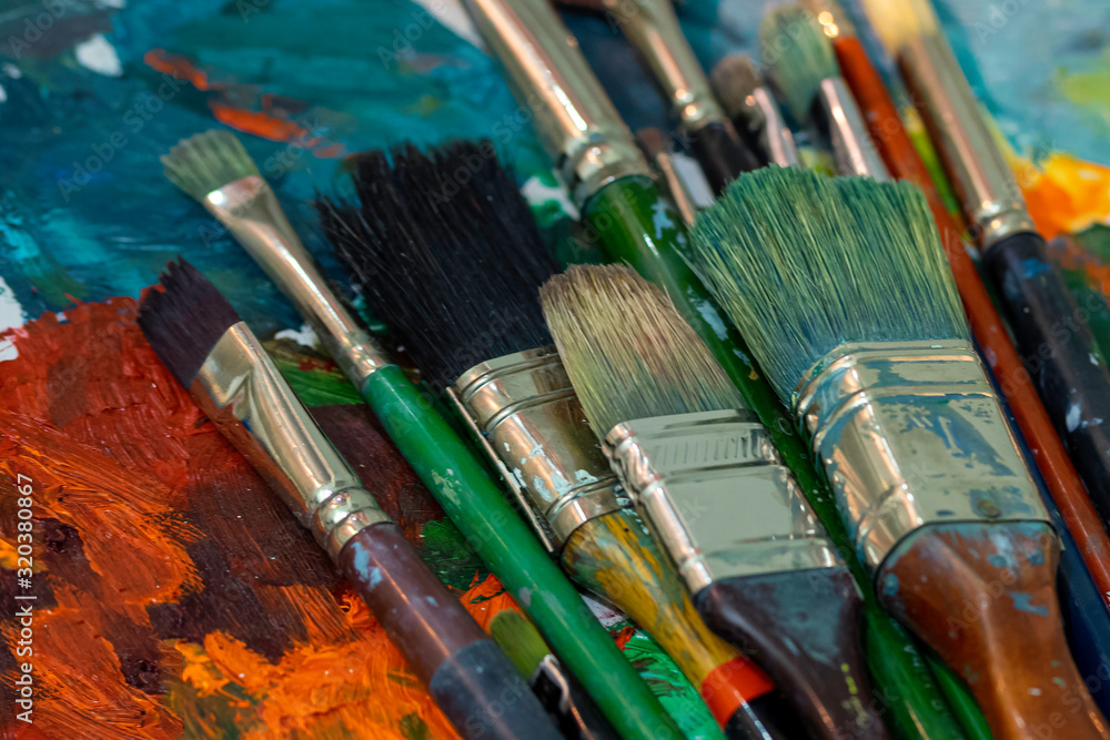 Colorful paint brushes. Art concept. Painting process. Colorful paint brushes. Art concept. Painting process.