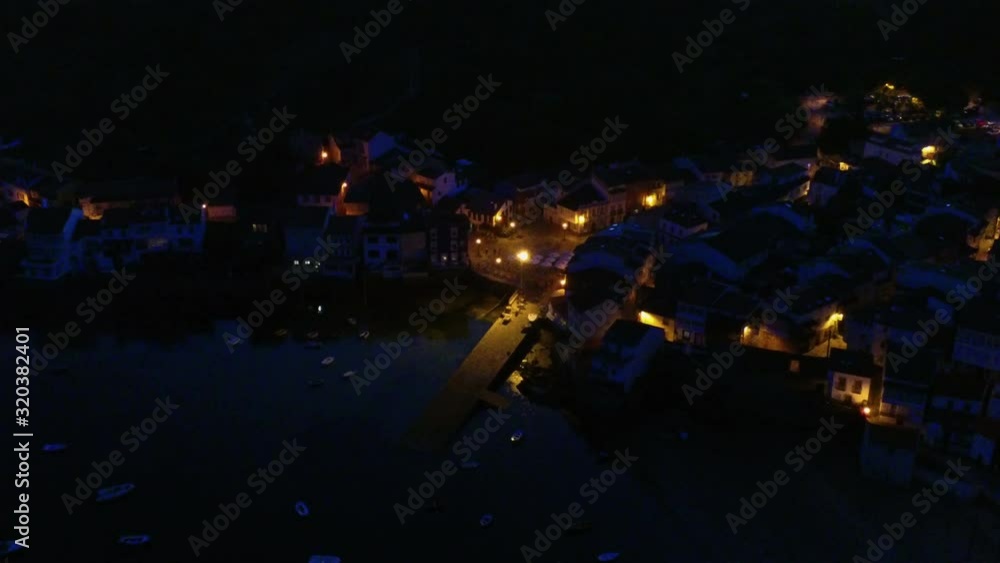 High angle zoom out of beautiful coastal town of Redes at night. Galicia,Spain High angle zoom out of beautiful coastal town of Redes at night. Galicia,Spain