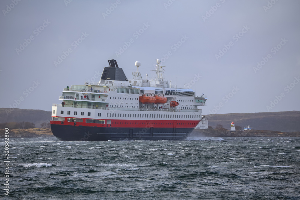 The coast passenger ship in strong wind on arrival Brønnøysund, Nodland county
