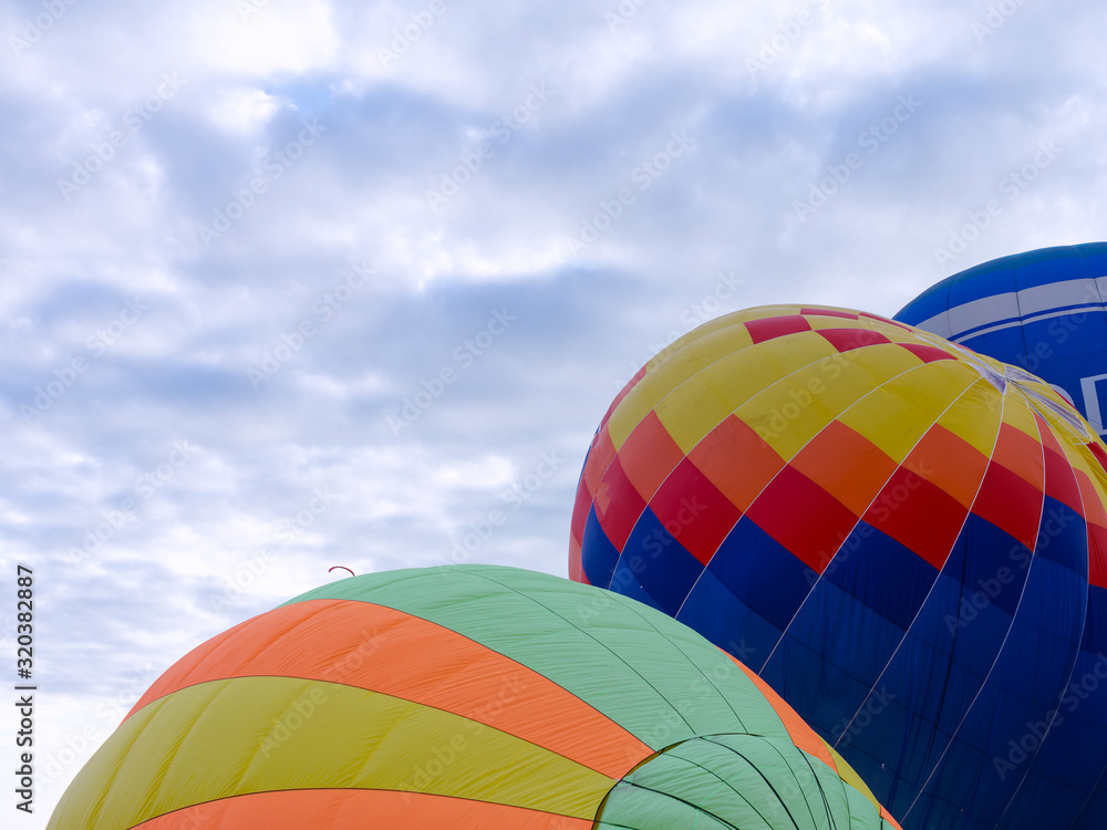 Fototapeta premium Balloons on the ground. Balloonists prepare the balloons for flight. Festival of aeronautics.