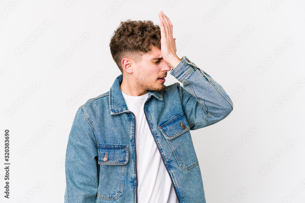 Young blond curly hair caucasian man isolated forgetting something, slapping forehead with palm and closing eyes. Young blond curly hair caucasian man isolated forgetting something, slapping forehead with palm and closing eyes.