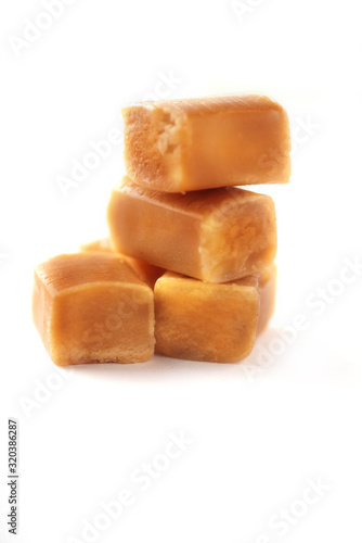 Brown caramel cubes isolated on white background