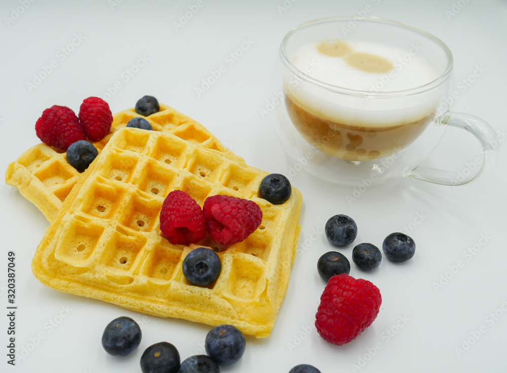 Closeup waffles with berries and cappuccino