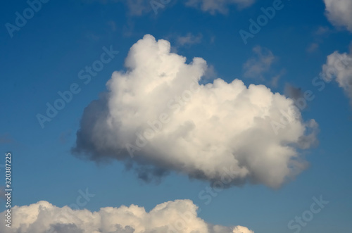 Blue sky with big white and grey clouds.
