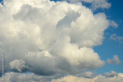 Blue sky with big white and grey clouds.