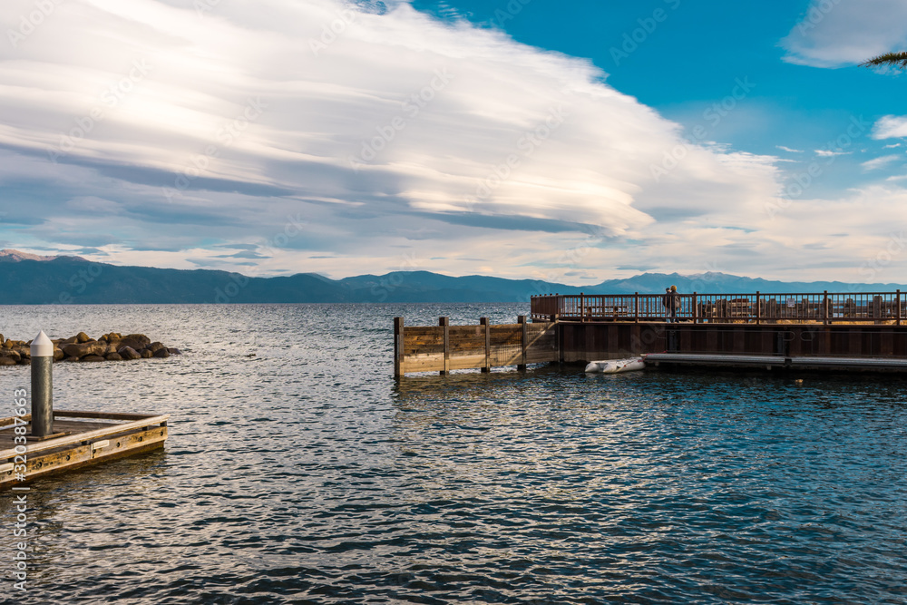Tourists enjoy the sunset with their smartphone from a dock in Tahoe Vista