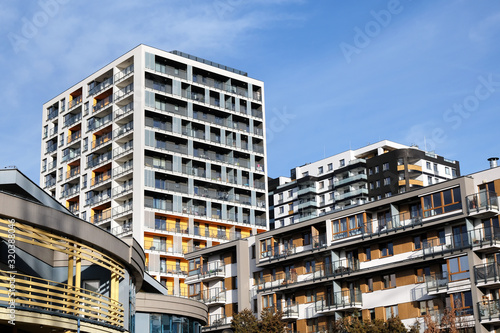 Facades of modern apartment buildings with balcony in contemporary residential district.