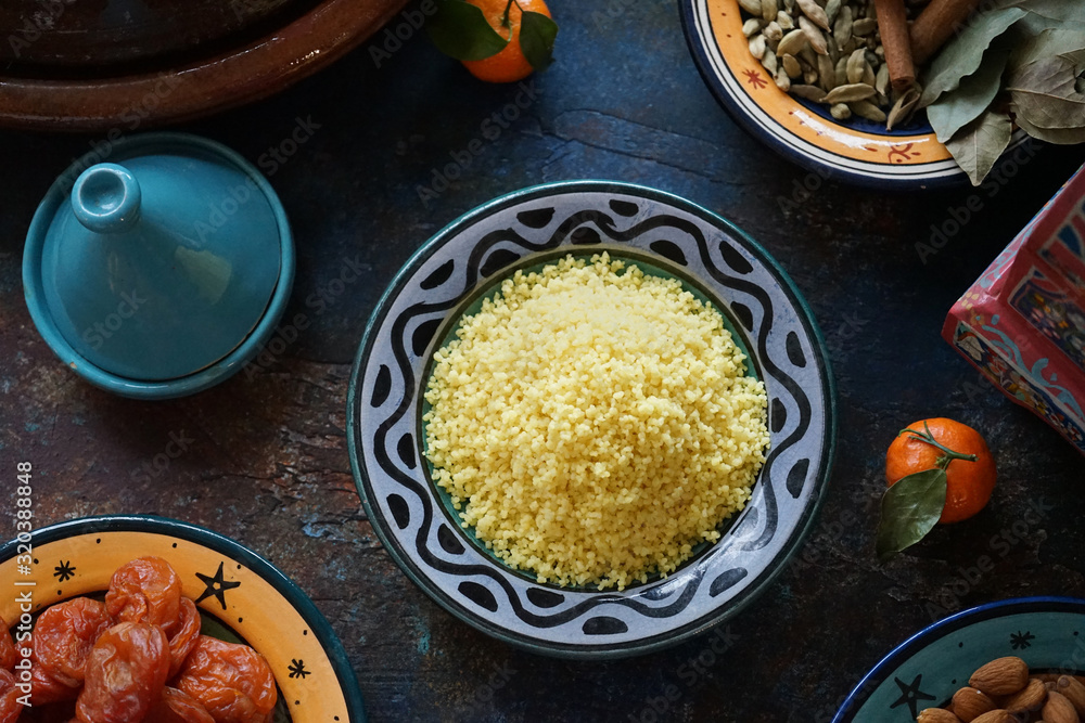 Bulgur porridge in a painted Eastern plate in the center of the table Mandarin dried apricots Eastern cuisine Bulgur porridge in a painted Eastern plate in the center of the table Mandarin dried apricots Eastern cuisine