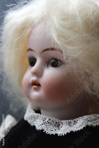 Canvas Print A beautifil porcelain antique doll portraying a little girl with blonde hair, an expensive collectible object and a popular hobby