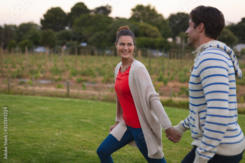 Happy young couple walking in the garden