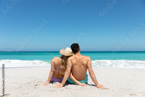 Young couple sitting at the beach