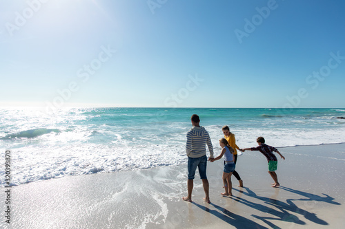 Parents and children walking in the water