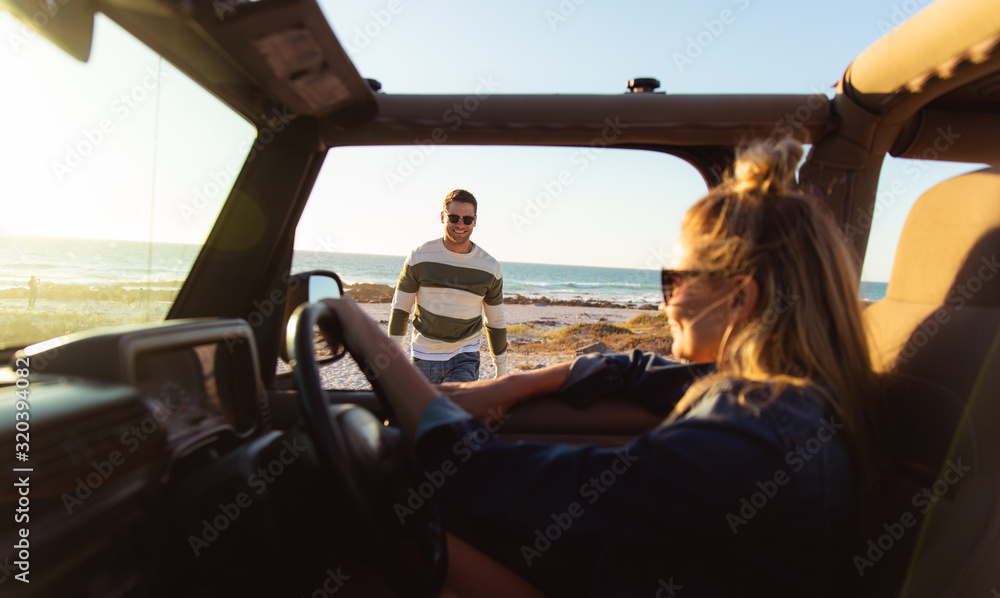 Couple with car at the beach