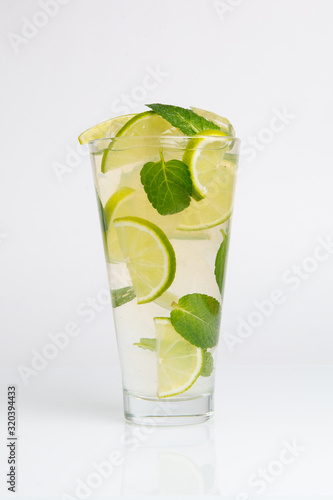 Cocktail with mint, lime and crushed ice on a white background